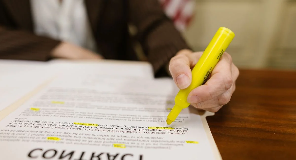 Dirigeant d'entreprise relisant un contrat de travail avec tickets restaurant sur bureau