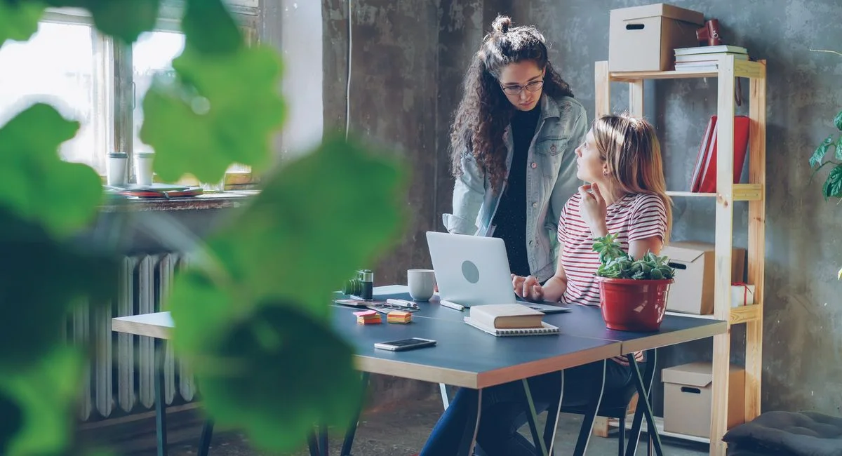 Une équipe technique discute d'architecture SaaS sur écran d'ordinateur portable